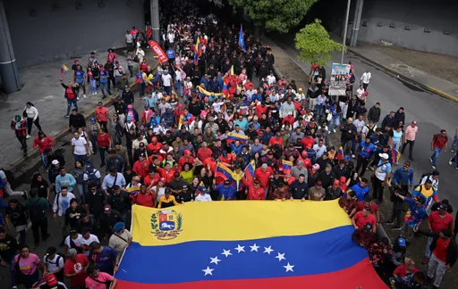 Thousands march in Venezuela against US ‘threats’ as Maduro mobilises militia