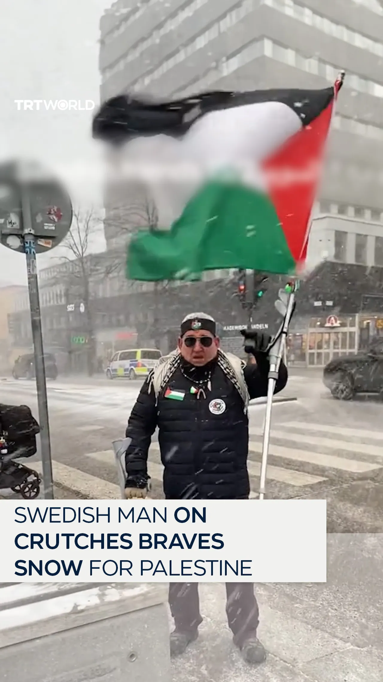 Swedish man on crutches braves snow to protest for Palestine.