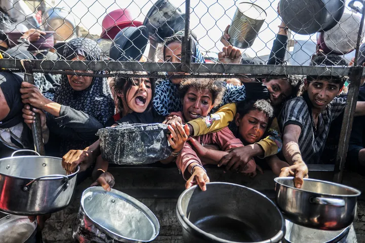 În imagini: Palestinienii înfometați caută hrană la noi puncte de distribuție