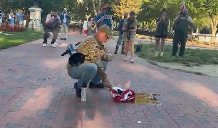 Man, claiming to be combat veteran, arrested for burning US flag to protest Trump order