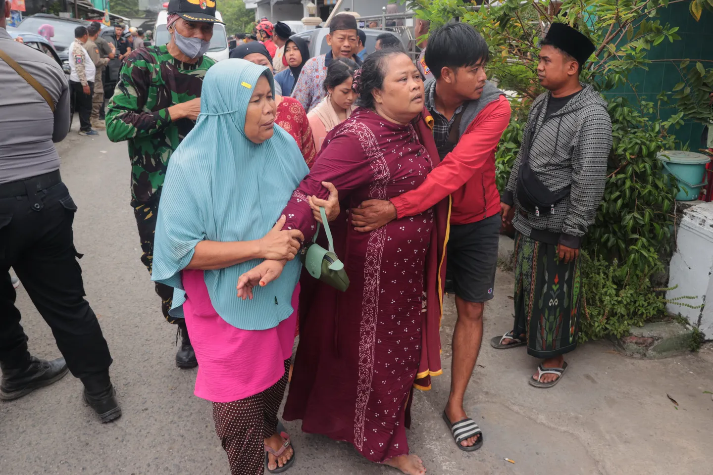 Keluarga berduka dan menunggu saat tim penyelamat menggali reruntuhan pondok pesantren di Sidoarjo