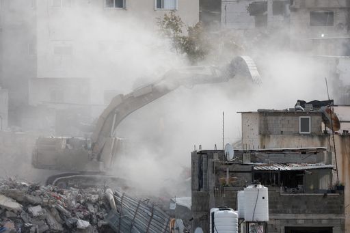 Israeli heavy machinery demolishes a Palestinian building at Nur Shams refugee camp near Tulkarm, in the occupied West Bank, on December 31, 2025.