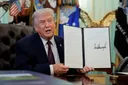 Trump signs executive order seeking to restrict mail-in voting