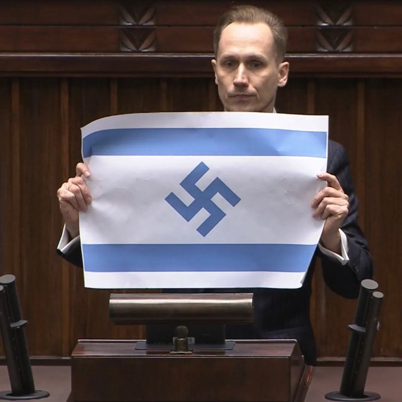 Polish lawmaker sparks controversy after displaying Israeli flag with Nazi swastika