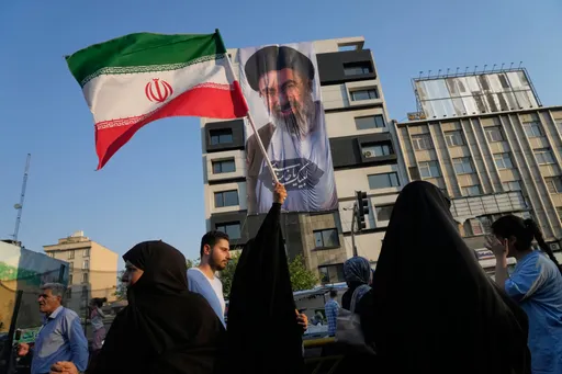Iranians strike wartime tone of defiance in massive Tehran rally