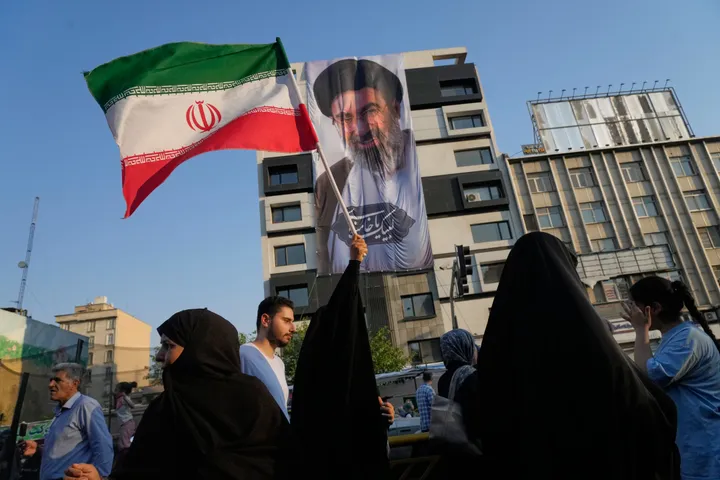 Iranians strike wartime tone of defiance in massive Tehran rally