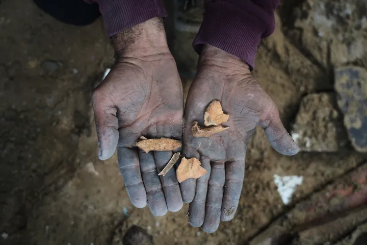 A father in Gaza searches rubble for his family's remains after Israeli air strike destroys home