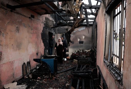 Palestinians inspect a damaged house burned by Israeli settlers, in Al-Fandaqumiya, near Jenin, in the occupied West Bank, on March 22, 2026.
